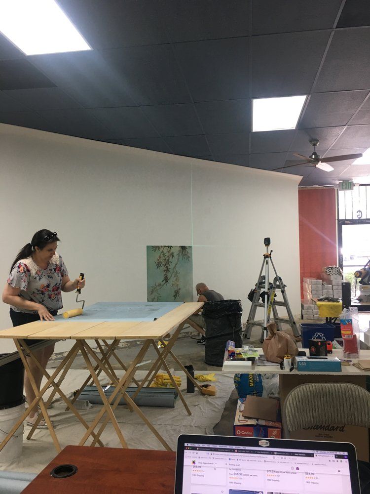 Robyn Valentino working at a pasting table on an installation site