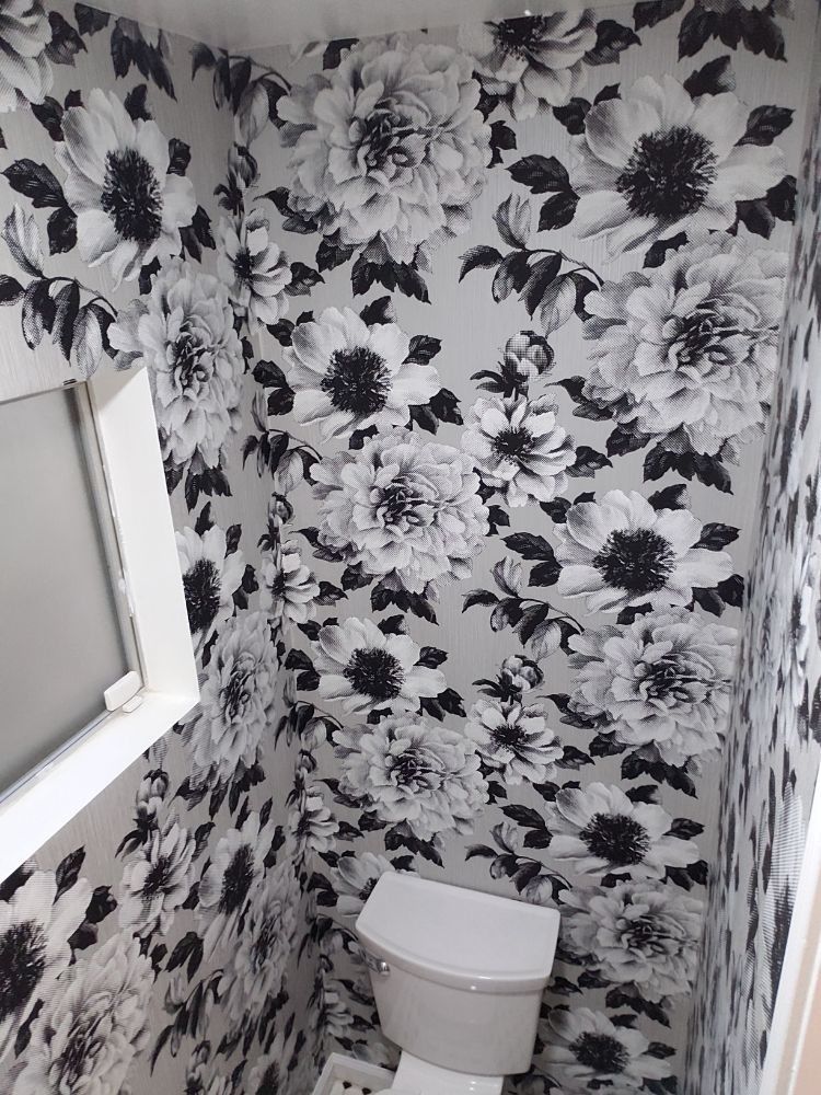 Bathroom with oversized black-and-white photographic floral wallpaper